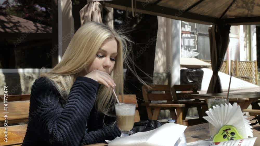 Pretty girl in cafe, blonde Sunny day Pretty girl in cafe, blonde Sunny day