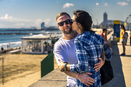 Photos Portrait of young and attractive couple close up standing next to the sandy beach