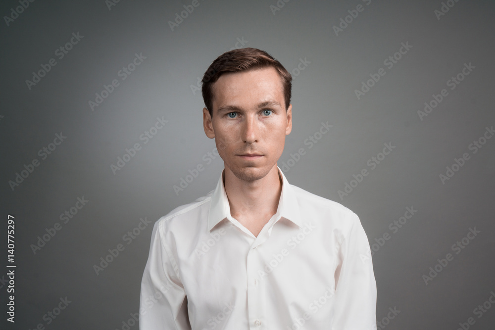 Business man in white shirt, portrait on grey background.