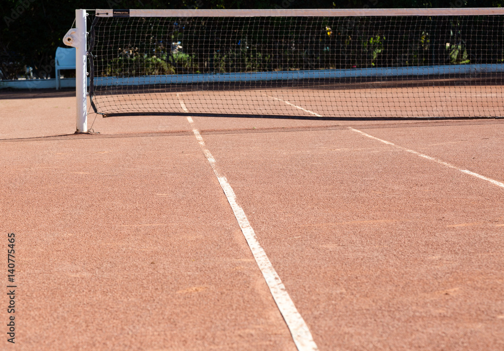 Fototapeta premium Orange brown sand empty private tennis court ready for game