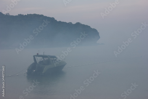 Blurred speed boat in the fog-covered sea.  