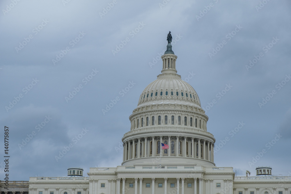 U.S. Capitol Dome and Flag on a Cloudy Day