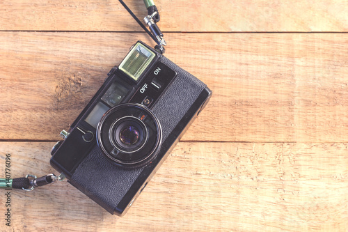 Old retro camera on wood table background ,Vintage style