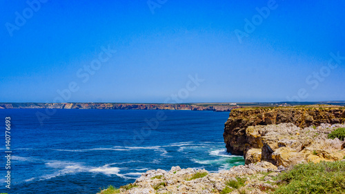 Ocean wave background. Cliff coastline in Sagres, Algarve, Portugal © EwaStudio