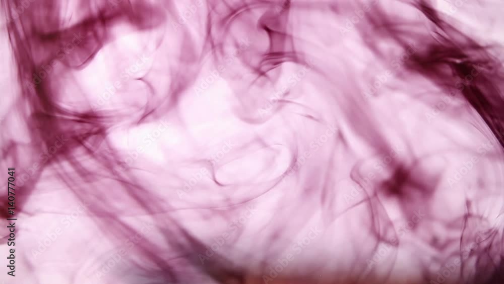 Dark red ink dissolves in clear water Dark red ink dissolves in clear water