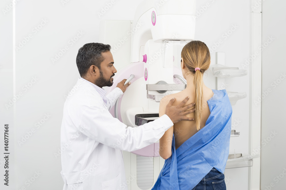 Doctor Standing Assisting Patient Undergoing Mammogram X-ray Tes Doctor Standing Assisting Patient Undergoing Mammogram X-ray Tes