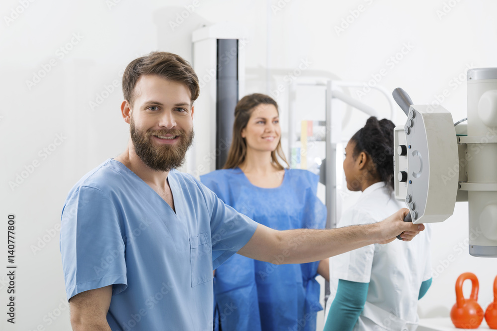 Radiologists Preparing For X-ray Over Female Patient In Hospital Radiologists Preparing For X-ray Over Female Patient In Hospital