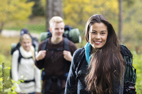 Portrait Of Beautiful Young Woman Hiking In Forest