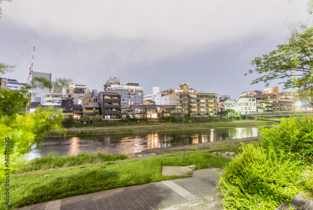 Kyoto buildings along city river at night, Japan