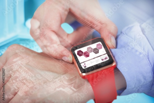 Composite image of businesswoman using smartwatch