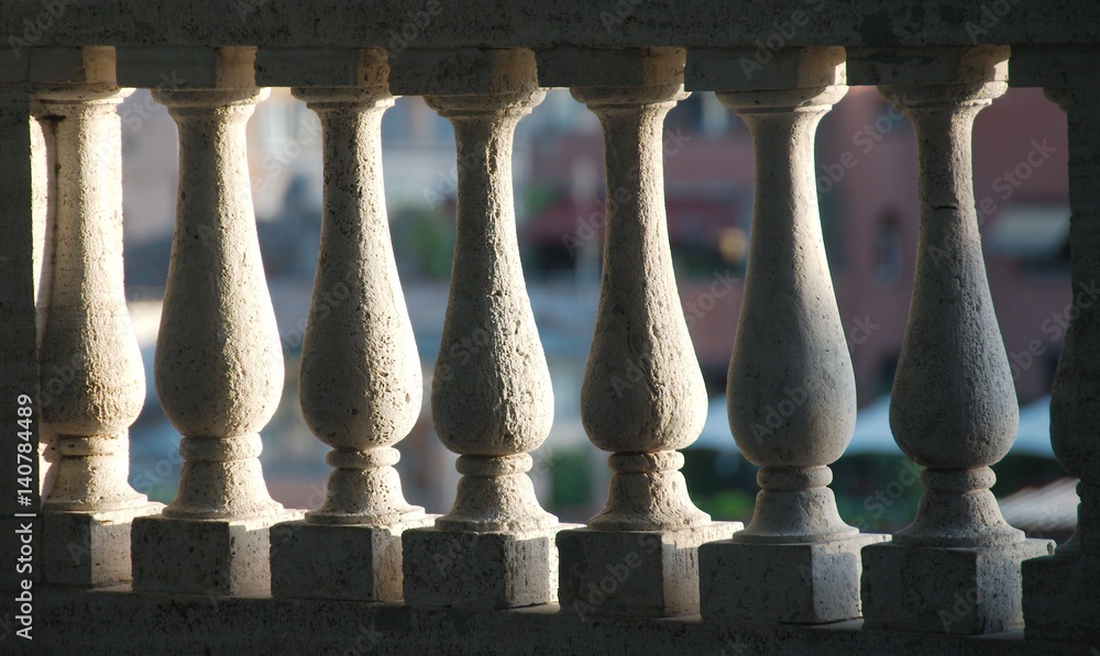 Fototapeta premium Detail of white stone balusters sunlit from one side