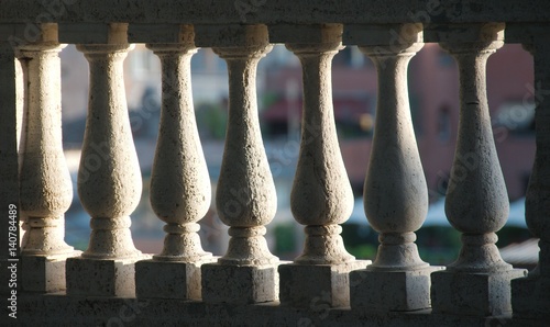 Detail of white stone balusters sunlit from one side