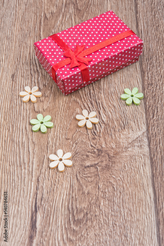 Gift with flowers on a wooden background