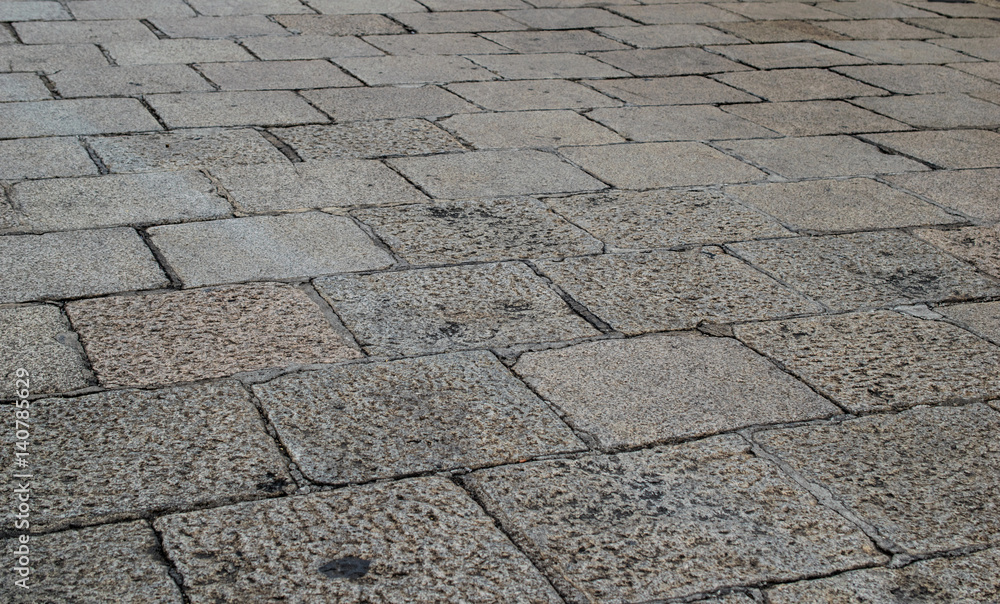 Obraz premium Ancient stone pavement, oled square rock floor.