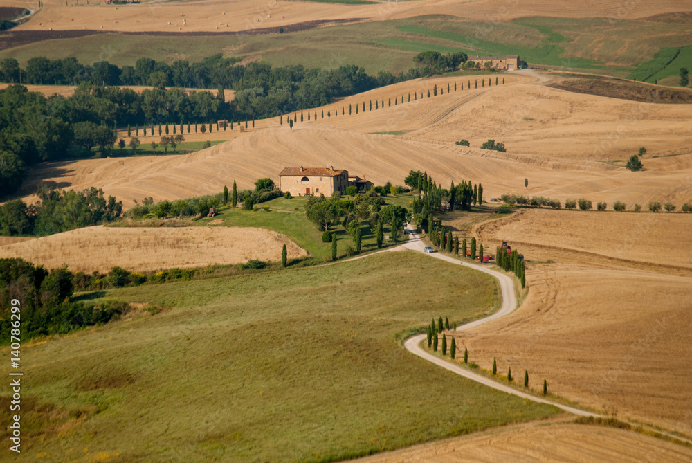 Road to the farm among tuscany hills