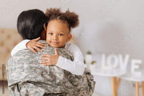 Loving mom returning home to her child photo