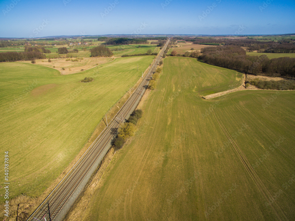 aerial view of railroad tracks in the countryside with agricultural fields