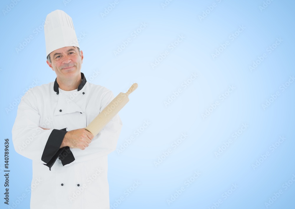 Chef with rolling pin against blue background Chef with rolling pin against blue background