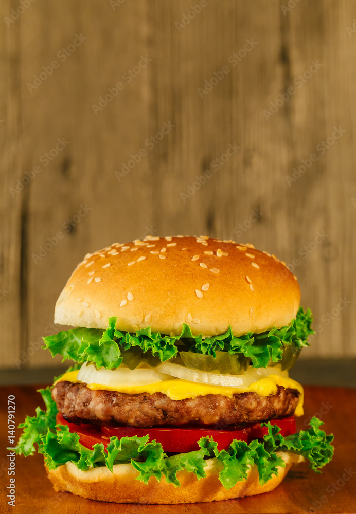 Classic deluxe cheeseburger with lettuce, onions, tomato and pickles
