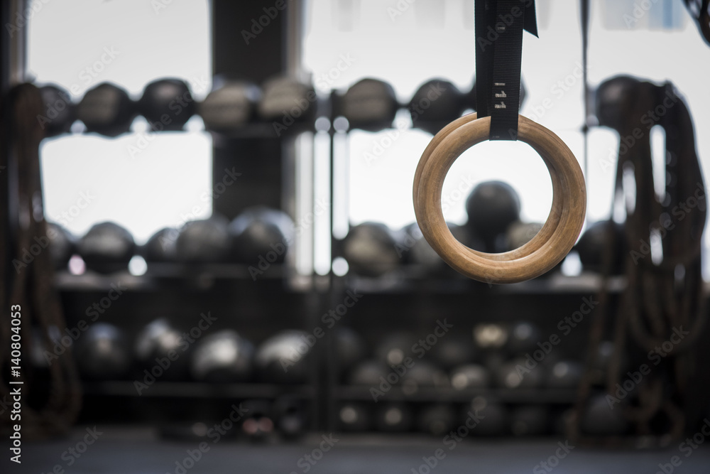 Φωτογραφία Closeup of gymnastic rings in gym with blurred equipment in background