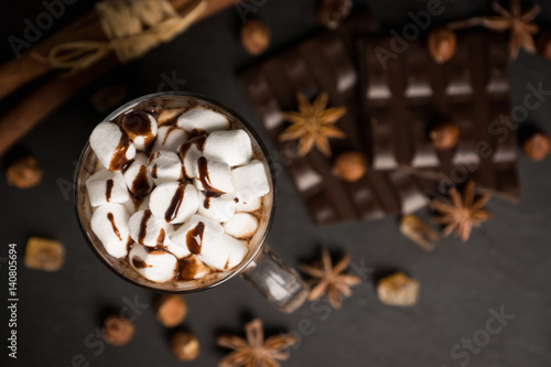 Hot chocolate with marshmallow on the wooden background. Shallow depth of field.