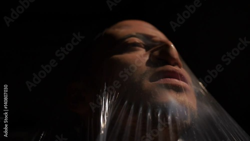 Man trapped in plastic struggling photo