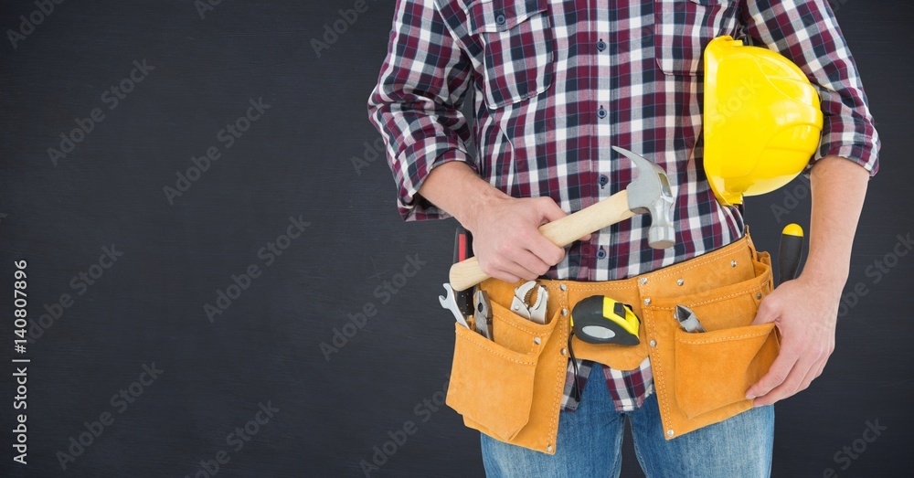 Composite image of Carpenter with hammer against blackboard Composite image of Carpenter with hammer against blackboard