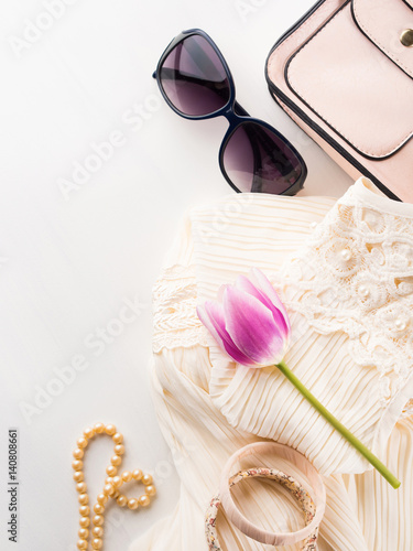 Woman clothes accessories fashion shopping. Romantic dress outfit with glasses and necklace bracelets. Summer elegant style look flat lay for blog lifestyle on white background