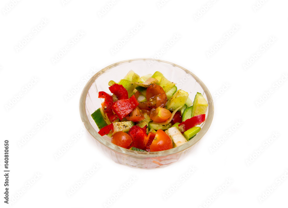 Vegetable salad pepper tomato cucumber in transparent bowl on white background Vegetable salad pepper tomato cucumber in transparent bowl on white background