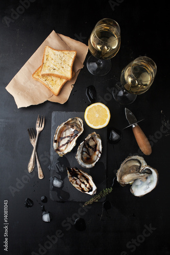 Fresh oysters with lemon and glasses of wine