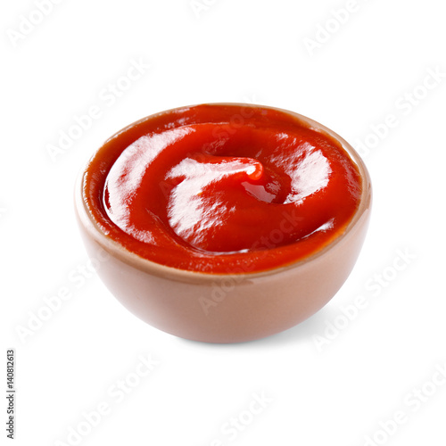 Ketchup in small bowl isolated on white background