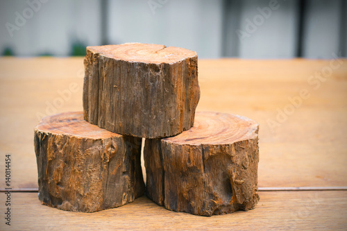 three of firewood on the wooden table © blindturtle