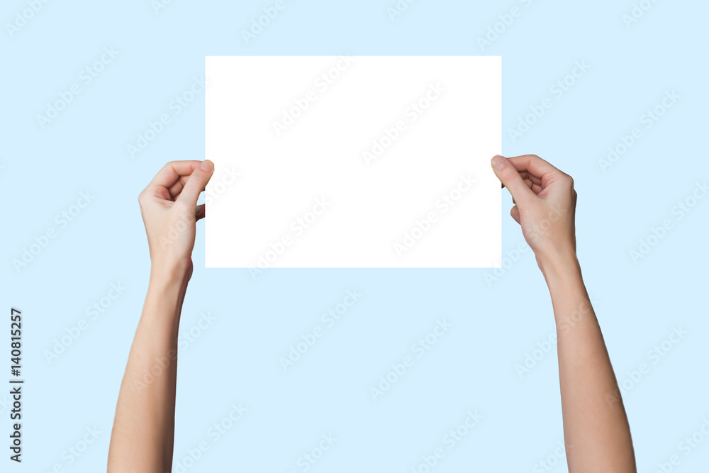 a sheet of paper in his hand, on a background a sheet of paper in his hand, on a background
