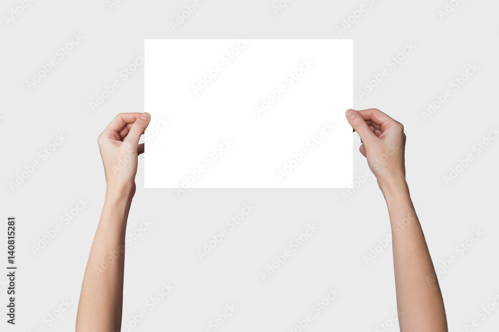 a sheet of paper in his hand, on a background a sheet of paper in his hand, on a background