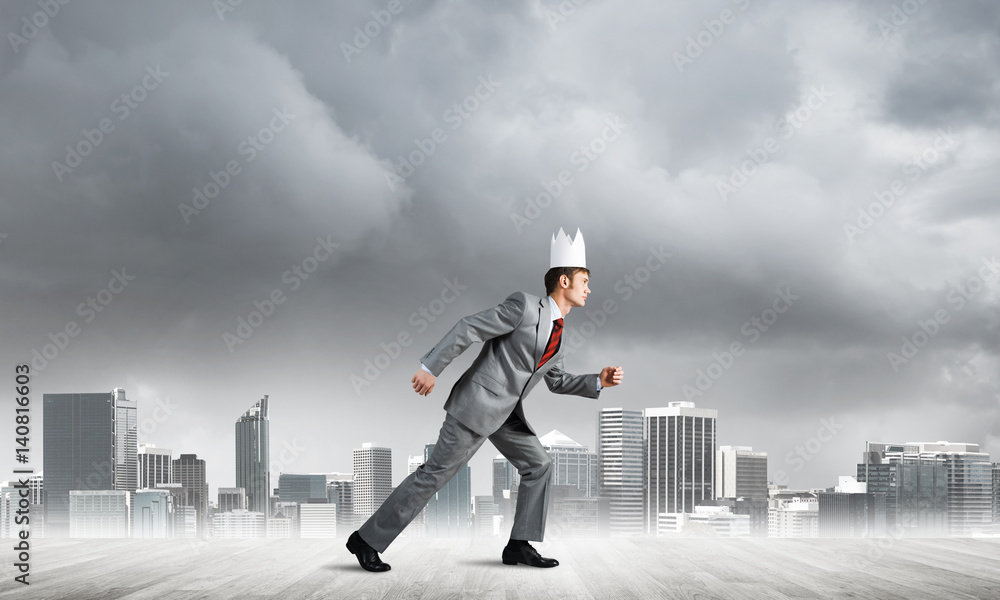King businessman in elegant suit running and modern cityscape at background King businessman in elegant suit running and modern cityscape at background