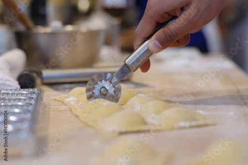 Person Uses Tool To Cut Ravioli Team Building Cooking