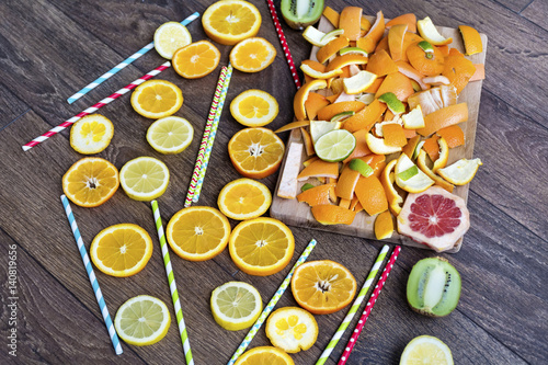 Assorted cut citrus fruits on wooden background