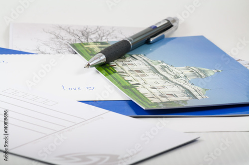 Write postcard to someone
Envelope,postcard and pen isolated on white background. 