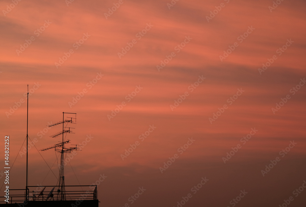 Silhouette of  TV Antenna against Beautiful Pink Cloudy Sky at the Twilight of Bangkok,Thailand