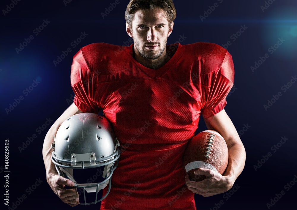 Portrait of confident athlete holding american ball and headwear
