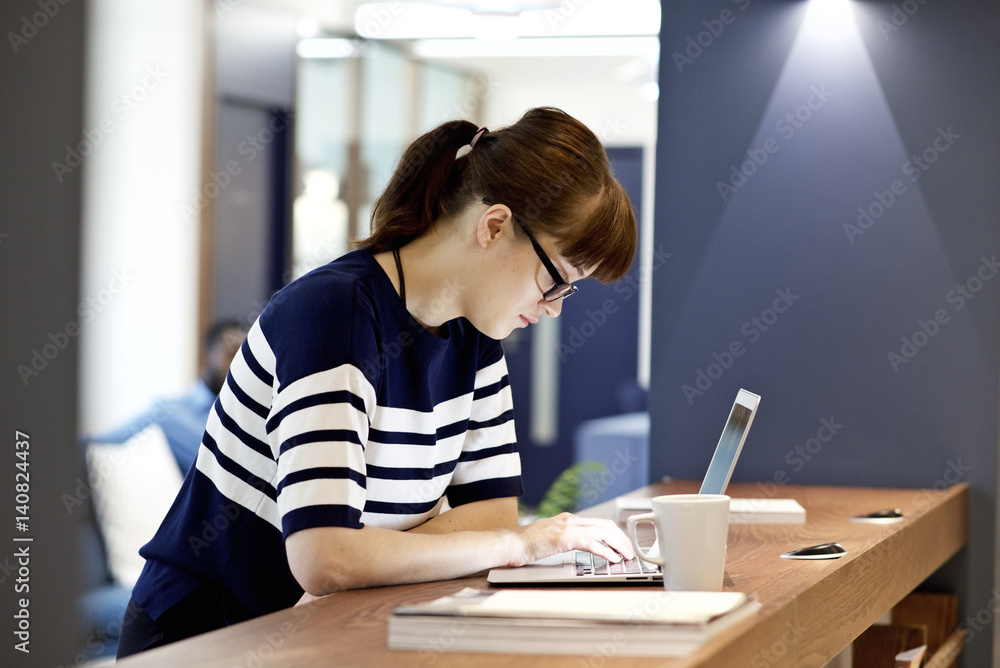 Young caucasian creative professional using a laptop in an office Young caucasian creative professional using a laptop in an office