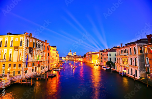 View of the Grand Canal in Venice at night with laser light projected into the sky.  © Javen