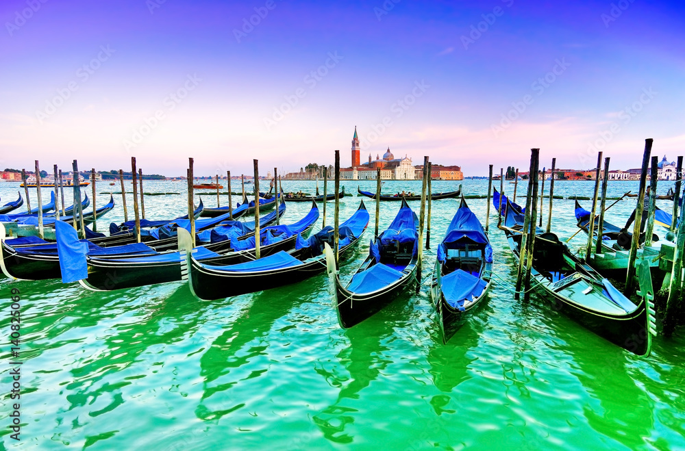 Gondolas moored by St Mark's Square at dusk in Venice 