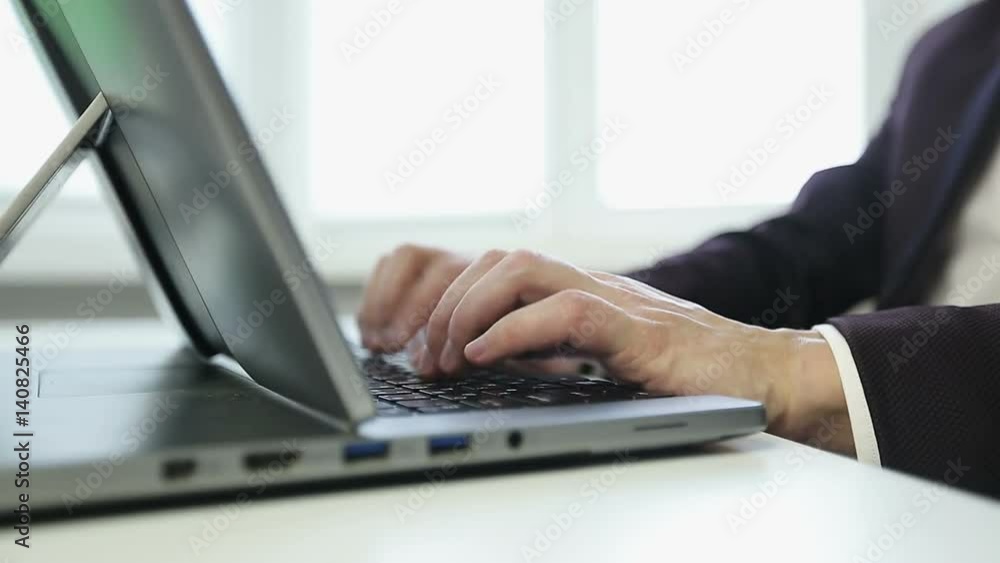 Close-up of the hands of a businessman working on a laptop. Close-up of the hands of a businessman working on a laptop.