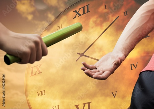 Fotografia Athlete passing the baton to teammate against clock background