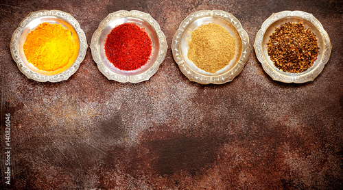 Spices powder and herbs on old textured background