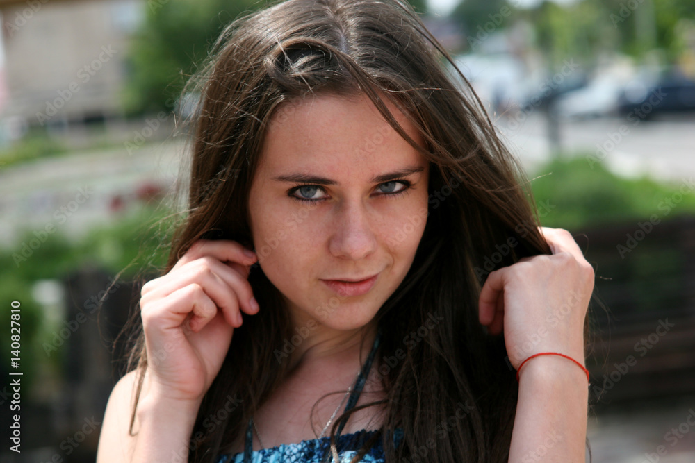 Brunette girl on the street with a cocky look Brunette girl on the street with a cocky look