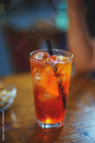 Refreshing traditional drinks on wooden table Aperol Spritz and sparkling water.