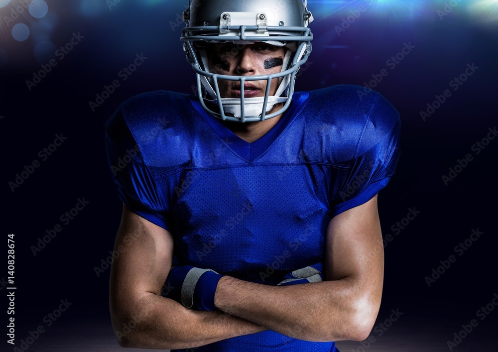 Portrait of american player in helmet standing with arms crossed