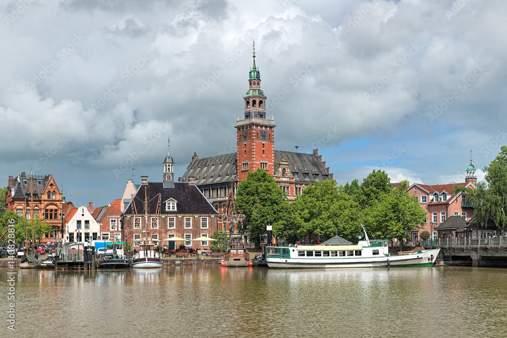 Leer, Germany. View from Leda river on the City Hall in Dutch Renaissance style, the Old Weigh House in Dutch classical Baroque style and the Tourist Harbor.